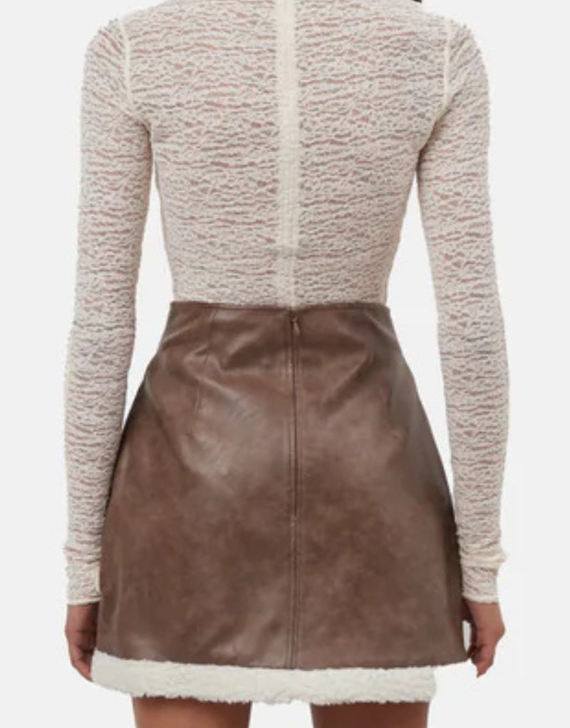 Back view of Ella Faux Shearling Mini Skirt - Women's High-Waisted Brown Leather Skirt with Shearling Trim and Sleek Finish.