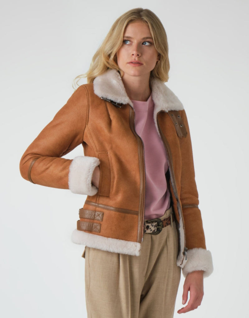 Women's tan sheepskin leather shearling jacket with plush white fur collar, zip-up front, and adjustable cuffs perfect for winter warmth and style.