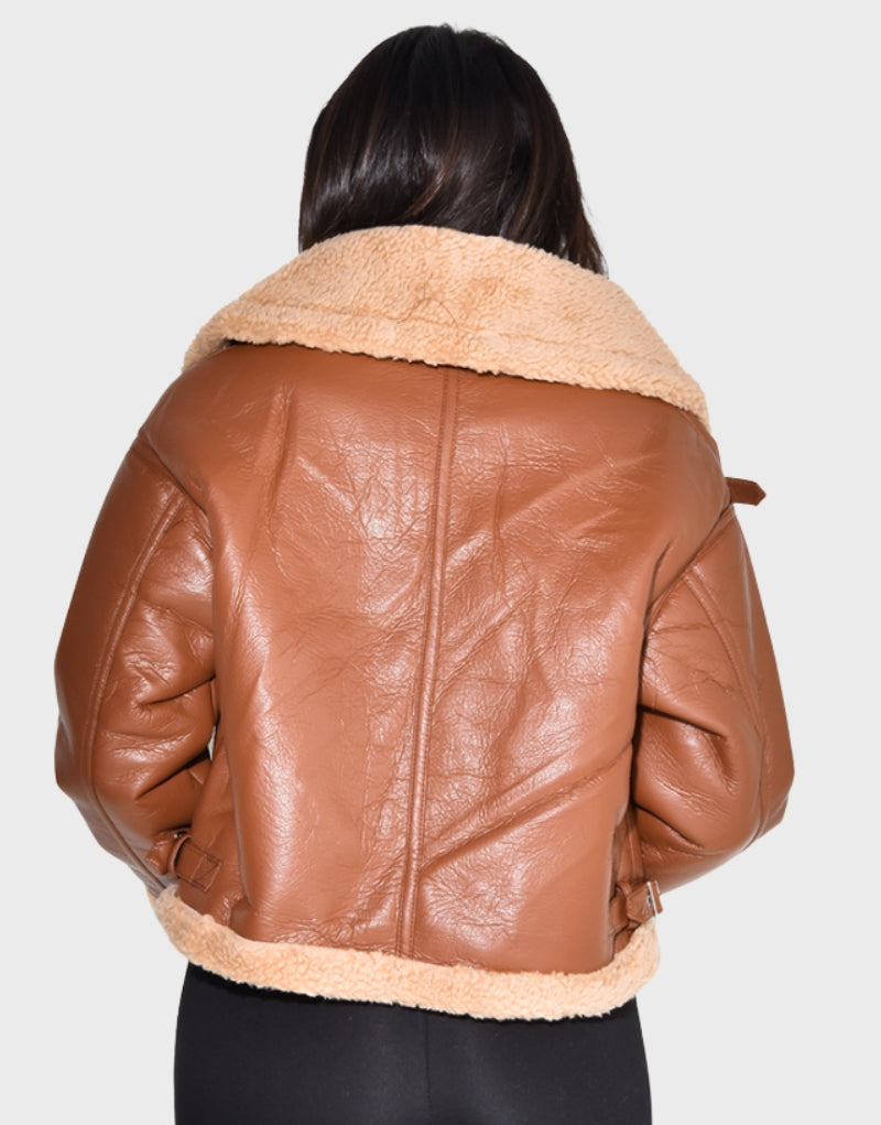 Back view of Florence Pugh-inspired brown cropped shearling jacket with plush fur collar and hem, showcasing premium leather design.