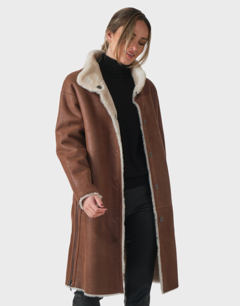 Front open view of the Victoria Beckham Shearling Leather Coat highlighting its luxurious interior shearling lining and button closure.