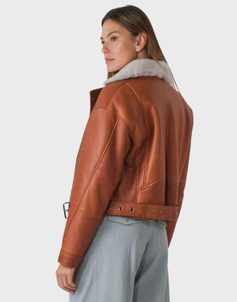 Brown leather biker jacket with faux shearling collar, zip-up front, and belted hem modern and warm outerwear for winter and fall outfits.