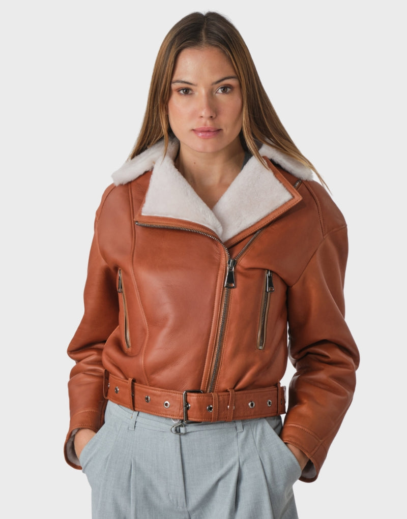 Stylish faux shearling biker jacket for women in brown leather with soft fur trim, side pockets, and adjustable cuffs ideal for casual and edgy looks.