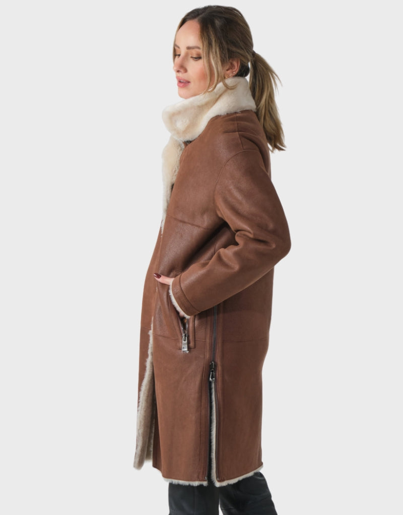 Side view of the Victoria Beckham Shearling Leather Coat with plush shearling collar, zippered pockets, and detailed stitching.