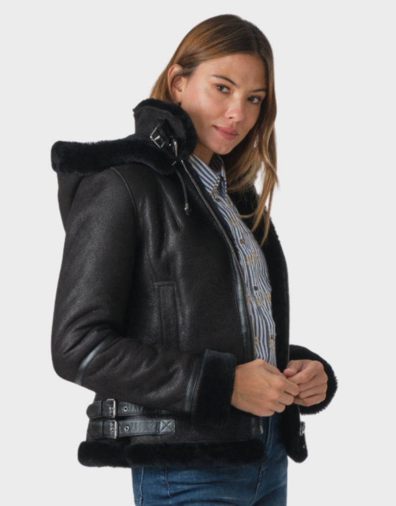 Black leather shearling-lined hoodie jacket for women featuring soft fur trim, zip closure, and a modern design for cozy and elegant winter wear.